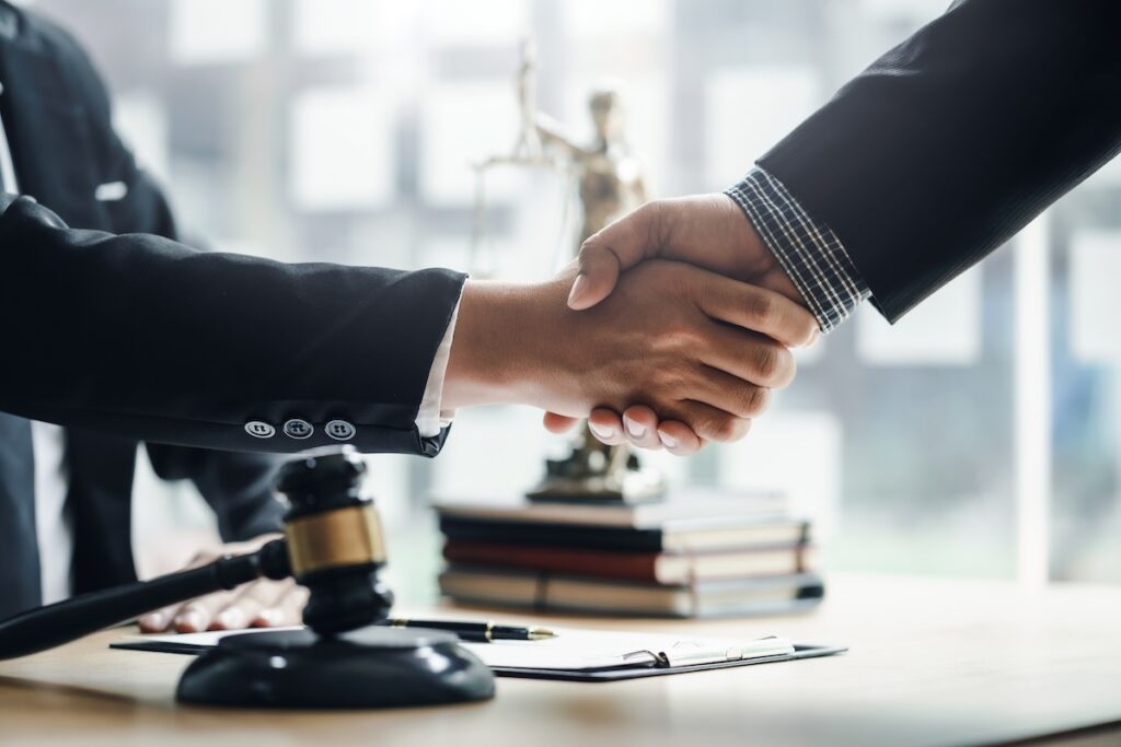 Attorney shaking hands with client