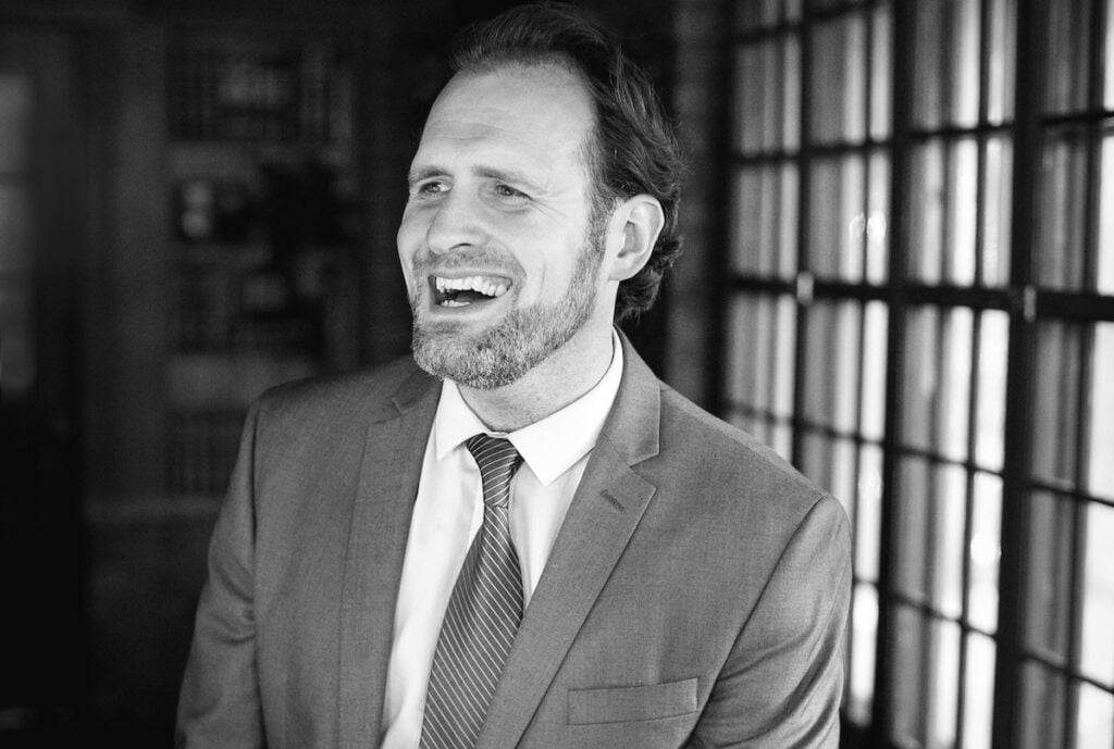 Josh smiling headshot black and white