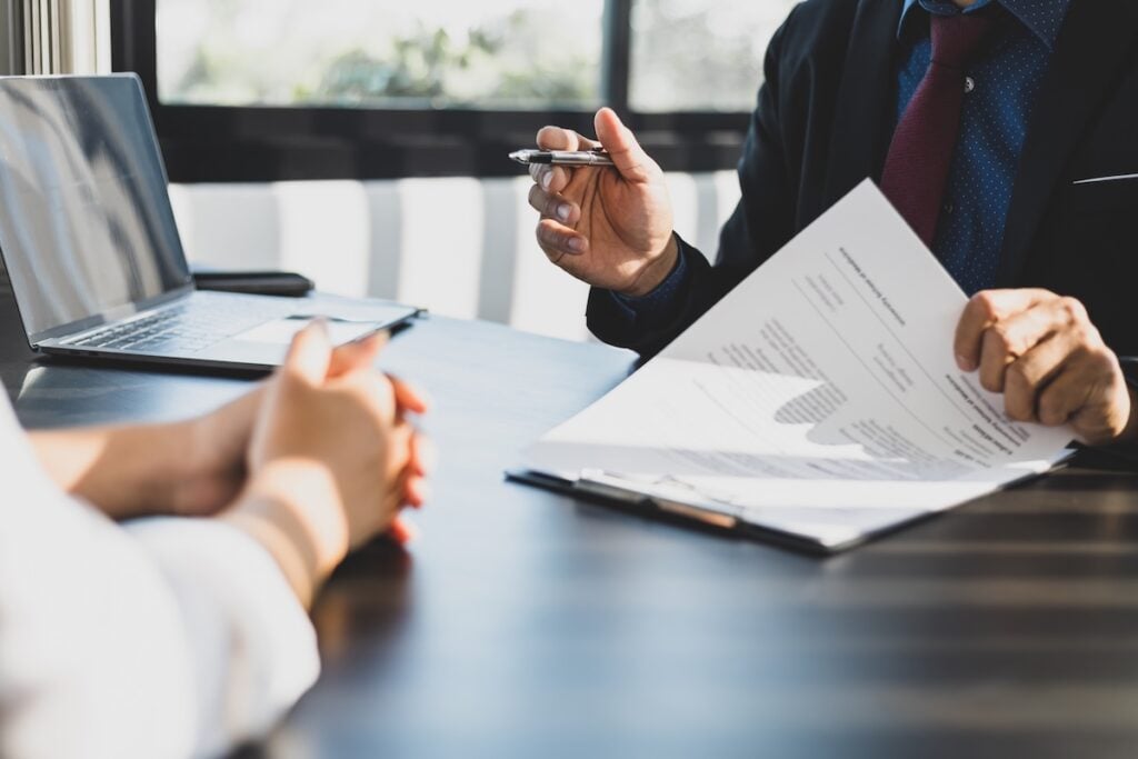 Lawyer in suit discussing case with client in office environment