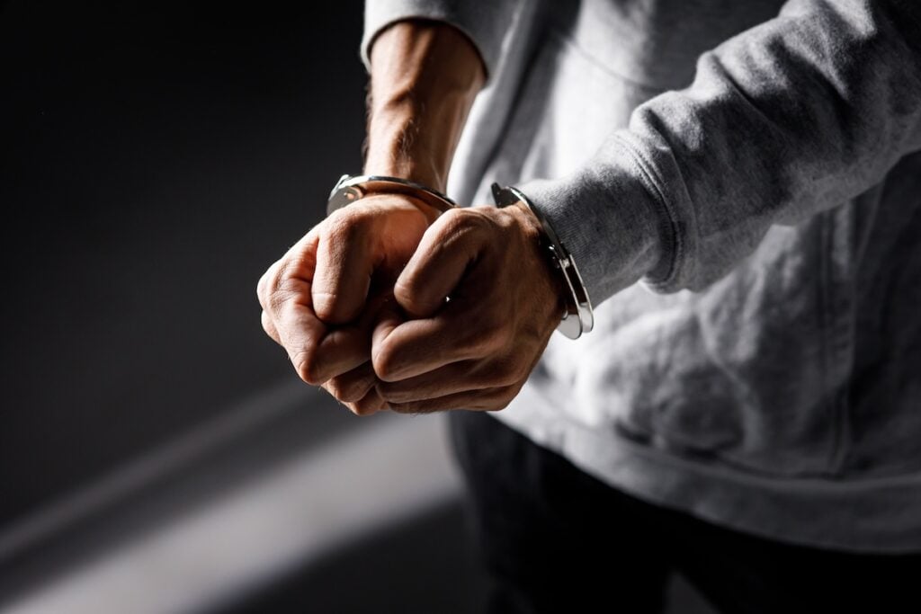 Closed fists in handcuffs