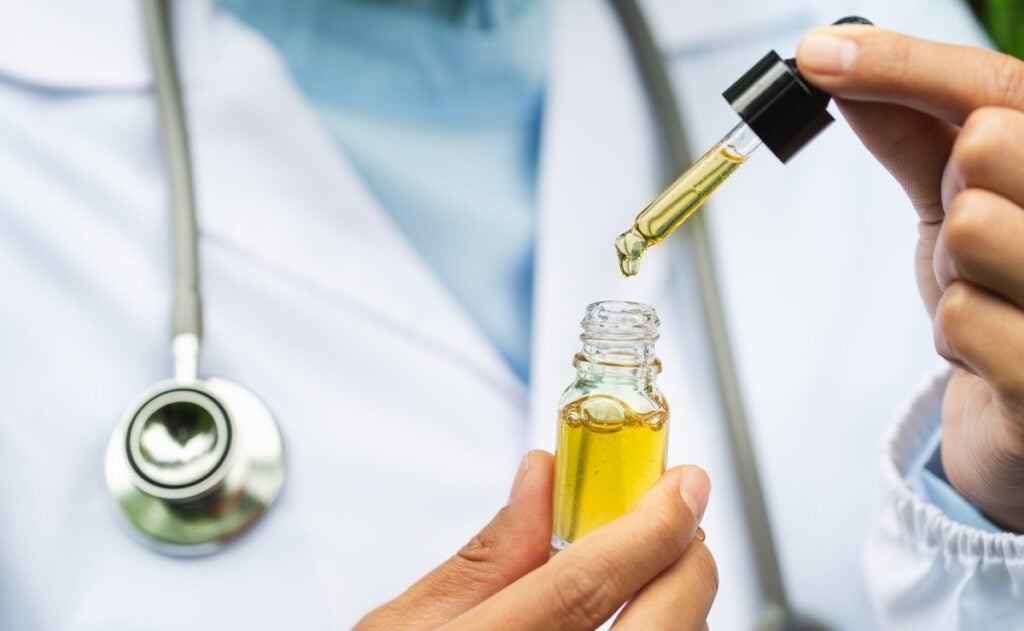 CBD Hemp oil, Doctor holding a bottle of hemp oil