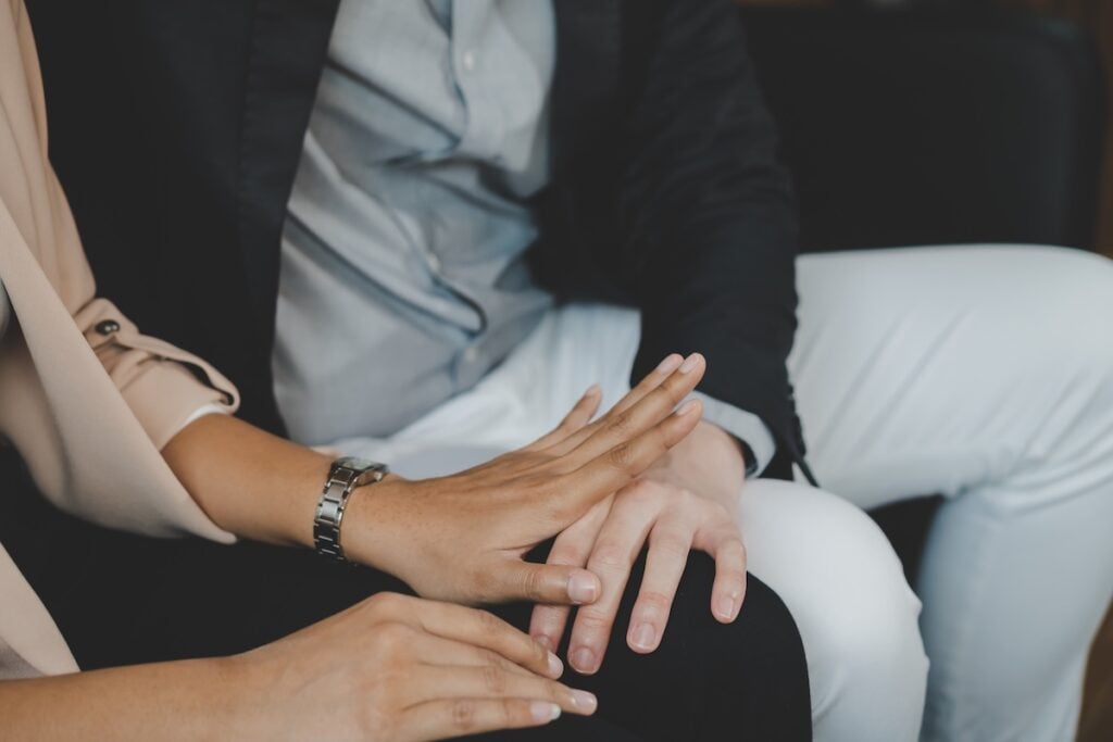 hand pushing away another persons hand