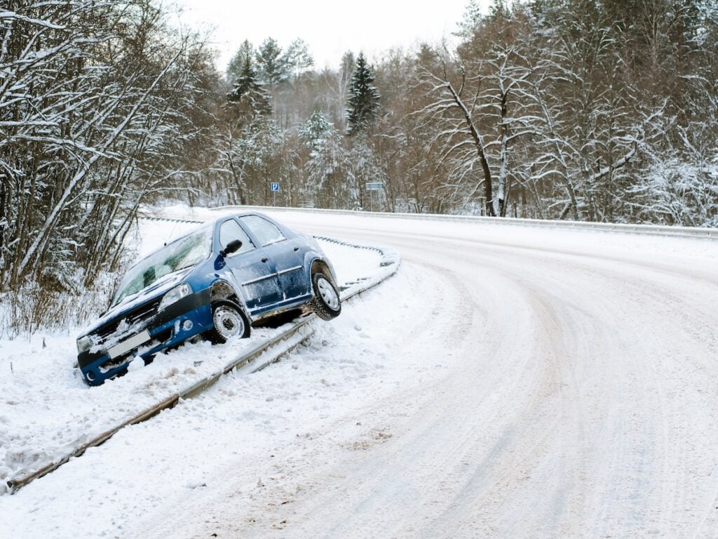 Abandoned car on the side of the road after a traffic accident.