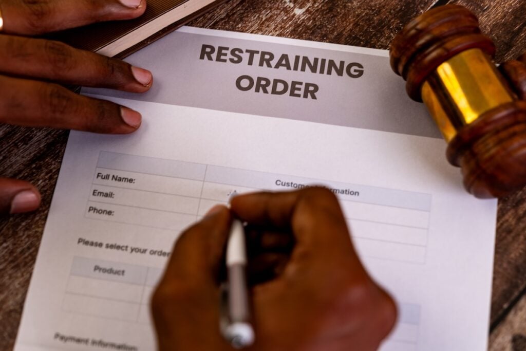 Person filling out a restraining order form