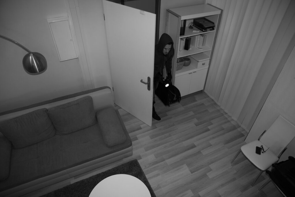 High Angle View Of A Robber Entering In Vacant House